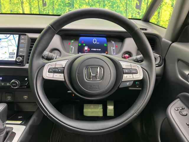 フィット ｅ：ＨＥＶリュクス　衝突軽減装置　禁煙車　９型ナビ　バックカメラ　ドラレコ　ＥＴＣ　レーダークルーズコントロール　クリアランスソナー　スマートキー　レーンアシスト　オートマチックハイビーム　オートエアコン（11枚目）