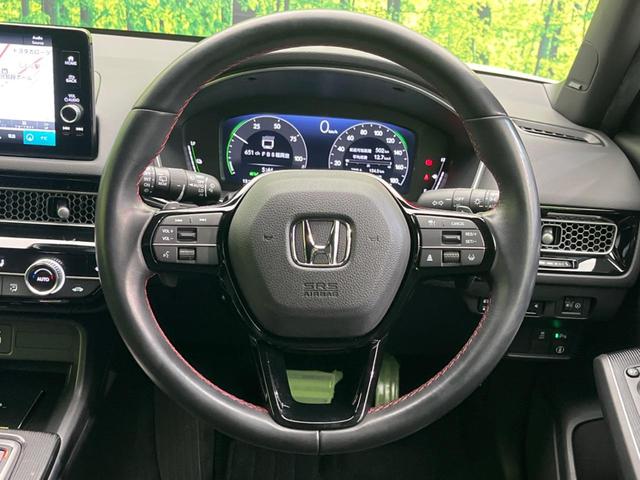 シビック ｅ：ＨＥＶ　純正９型ナビ　バックカメラ　ＢＯＳＥサウンドシステム　衝突軽減装置　レーダークルーズ　禁煙車　ハーフレザーシート　シートヒーター　パワーシート　ドラレコ　コーナーセンサー　レーンキープ　スマートキー（11枚目）