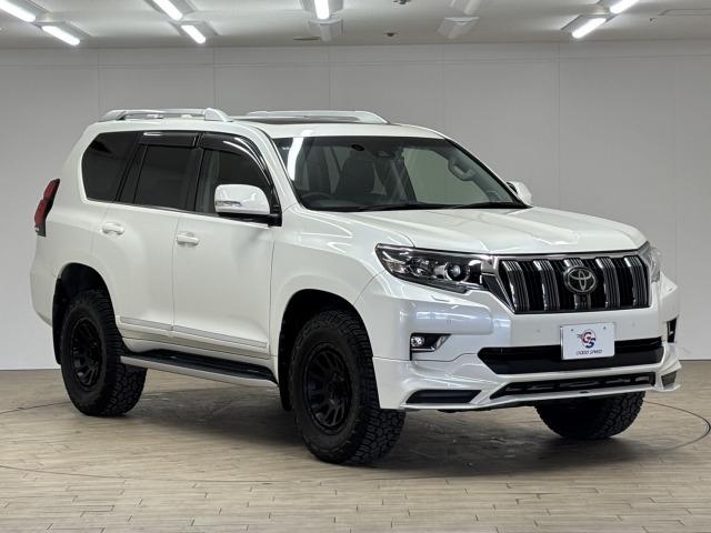 ランドクルーザープラド ＴＸ　Ｌパッケージ　ＴＲＤエアロ／サンルーフ／全周囲／ルーフレール／デルタフォース　オーバル１７インチＡＷ／黒革／純正９型ナビ地デジ／ダウンヒルアシスト／センターデフロック／ベンチレーション／追従クルコン／レーンキープ（64枚目）
