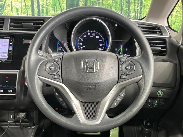 フィットハイブリッド F 禁煙車 純正8型SDナビ バックカメラ 衝突被害軽減システム レーダークルーズ ドラレコ スマートキー ビルトインETC 車線逸脱警報 オートエアコン Bluetooth CD DVD フルセグTV(11枚目)