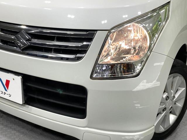 ワゴンＲ ＦＸリミテッドＩＩ　ＳＤナビ　禁煙車　スマートキー　ＥＴＣ　純正１４インチアルミ　盗難防止装置　革巻きステアリング　オートエアコン　地デジ　電動格納ミラー　プライバシーガラス（12枚目）