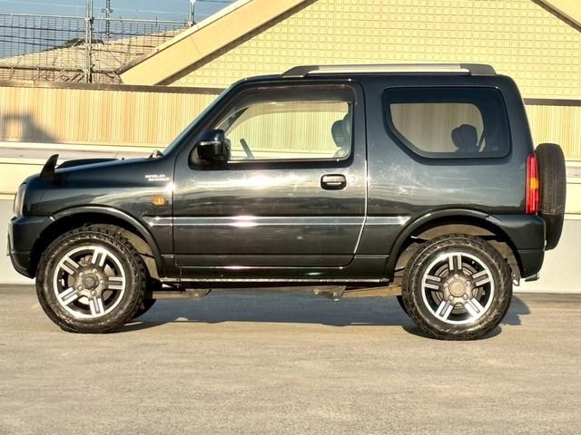 ジムニー ワイルドウインド　５速ＭＴ／パートタイム４ＷＤ／ルーフレール／背面タイヤ／シートヒーター／純正１６インチアルミ／ＣＤオーディオ／ミラーウィンカー／パワステ／パワーウィンドウ／エアコン／エアバック／革巻ステアリング（3枚目）