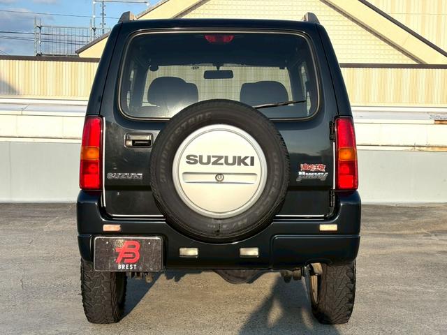 ジムニー ワイルドウインド　５速ＭＴ／パートタイム４ＷＤ／ルーフレール／背面タイヤ／シートヒーター／純正１６インチアルミ／ＣＤオーディオ／ミラーウィンカー／パワステ／パワーウィンドウ／エアコン／エアバック／革巻ステアリング（4枚目）