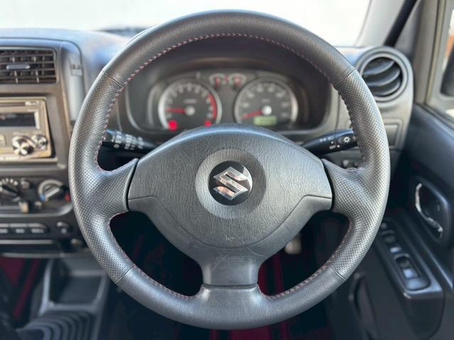 ジムニー ワイルドウインド　５速ＭＴ／パートタイム４ＷＤ／ルーフレール／背面タイヤ／シートヒーター／純正１６インチアルミ／ＣＤオーディオ／ミラーウィンカー／パワステ／パワーウィンドウ／エアコン／エアバック／革巻ステアリング（12枚目）