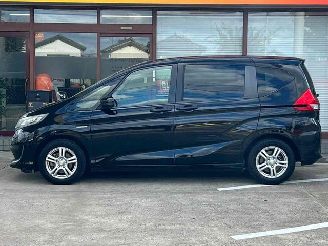 フリードハイブリッド ハイブリッド・ＥＸ　ホンダセンシング／両側電動スライドドア／純正ナビ／フリップダウンモニター／バックカメラ／黒革コンビシート／シートヒーター／ＥＴＣ／ヒーテッドドアミラー／ブラック木目インパネ／プラズマクラスター／禁煙（13枚目）