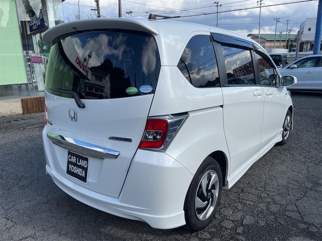 フリードハイブリッド ハイブリッド プレミアムエディション ハイブリッドプレミアムエディション CVT アイドリングストップ キーレスエントリー スマートキー 両側電動スライドドア ナビ バックカメラ 前方ドライブレコーダー フリップダウンモニター(6枚目)