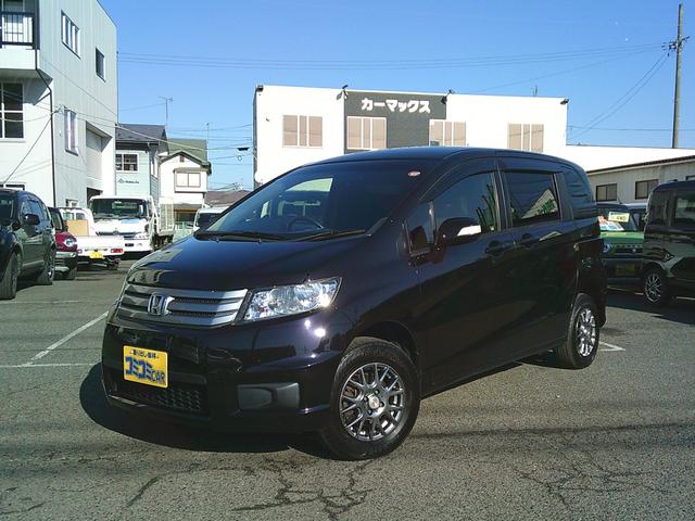 フリードスパイク Ｇ　ジャストセレクション　４ＷＤ車　ディスチャージライト　クルーズコントロール　両側パワースライドドア　社外ナビゲーション　フルＴＶ　バックカメラ　ブルートゥースオーディオ　ＤＶＤ再生　ワイパーデアイサ　社外アルミ　純正ＥＴＣ（8枚目）