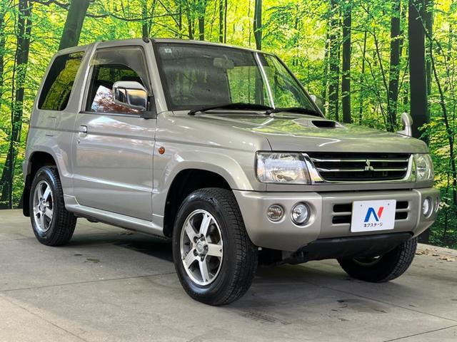 パジェロミニ アクティブフィールドエディション 4WD 純正15インチアルミ CD DVD再生 ナビ 電動格納ミラー プライバシーガラス グレーファブリックコンビシート リアワイパー メッキ加飾付フロントグリル 背面ハードカバー 革巻きステアリング(16枚目)