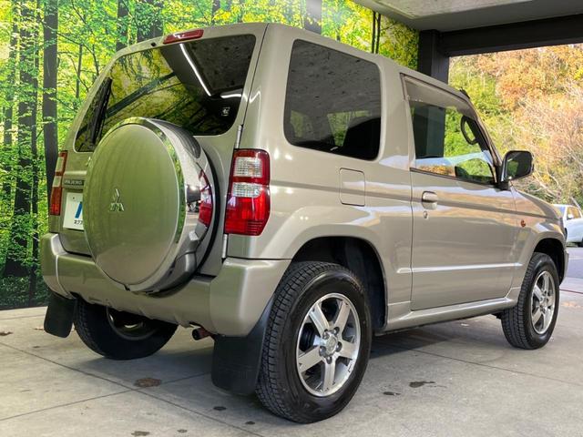 パジェロミニ アクティブフィールドエディション 4WD 純正15インチアルミ CD DVD再生 ナビ 電動格納ミラー プライバシーガラス グレーファブリックコンビシート リアワイパー メッキ加飾付フロントグリル 背面ハードカバー 革巻きステアリング(17枚目)