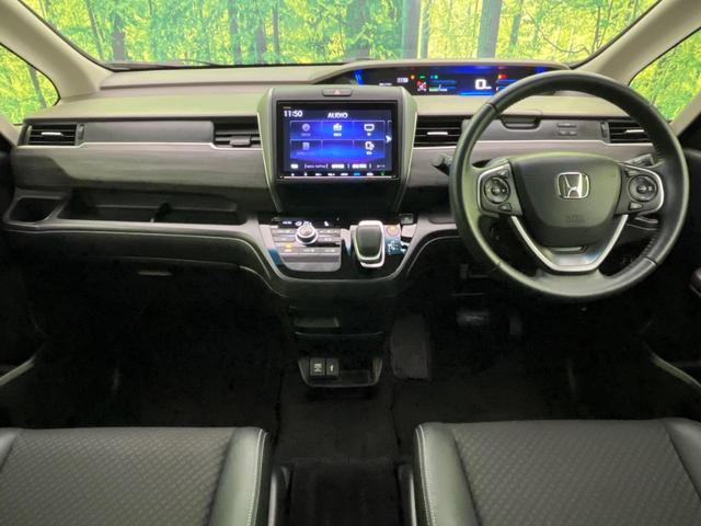 フリードハイブリッド ハイブリッド・Gホンダセンシング 両側電動ドア 純正9型ナビ バックカメラ アダプティブクルーズ スマートキー ハーフレザーシート ETC 車線逸脱警報 オートライト オートエアコン 純正15インチAW 革巻きステアリング(2枚目)