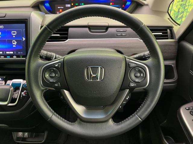 フリードハイブリッド ハイブリッド・Gホンダセンシング 両側電動ドア 純正9型ナビ バックカメラ アダプティブクルーズ スマートキー ハーフレザーシート ETC 車線逸脱警報 オートライト オートエアコン 純正15インチAW 革巻きステアリング(12枚目)