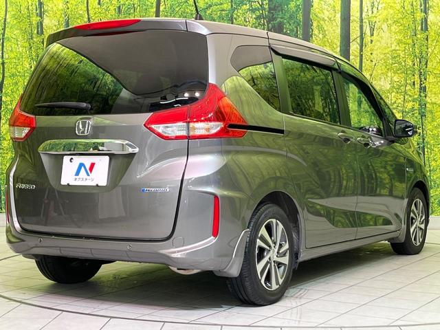 フリードハイブリッド ハイブリッド・Gホンダセンシング 両側電動ドア 純正9型ナビ バックカメラ アダプティブクルーズ スマートキー ハーフレザーシート ETC 車線逸脱警報 オートライト オートエアコン 純正15インチAW 革巻きステアリング(18枚目)