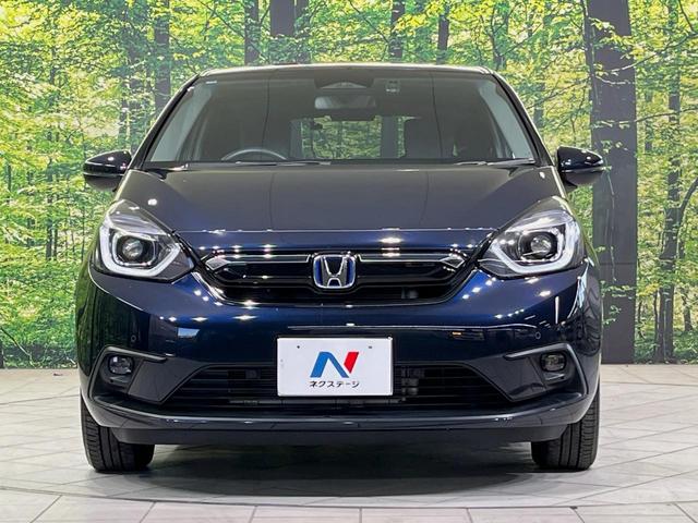 フィット e:HEVホーム 純正9型ナビ バックカメラ 衝突軽減装置 レーダークルーズ 禁煙車 ハーフレザーシート 前後ドラレコ コーナーセンサー スマートキー LEDヘッドライト ETC オートハイビーム 革巻きハンドル(14枚目)