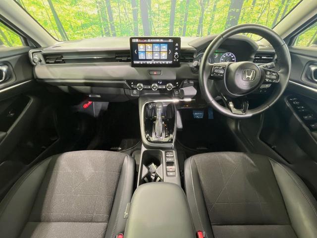 ヴェゼル ｅ：ＨＥＶ　Ｚ　メーカー９型ナビ　バックカメラ　衝突軽減装置　レーダークルーズ　禁煙車　パワーバックドア　シートヒーター　ハーフレザーシート　ドラレコ　コーナーセンサー　スマートキー　ＬＥＤヘッドライト　ＥＴＣ２．０（2枚目）