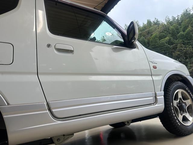 ジムニー ワイルドウインド　ルーフキャリア　ＥＴＣ　専用カバー付き背面タイヤ　フォグランプ　シートヒーター　ターボ　ミラーヒーター　４速ＡＴ　キーレス　ナビ　フルセグＴＶ　純正１６インチアルミホイール（33枚目）