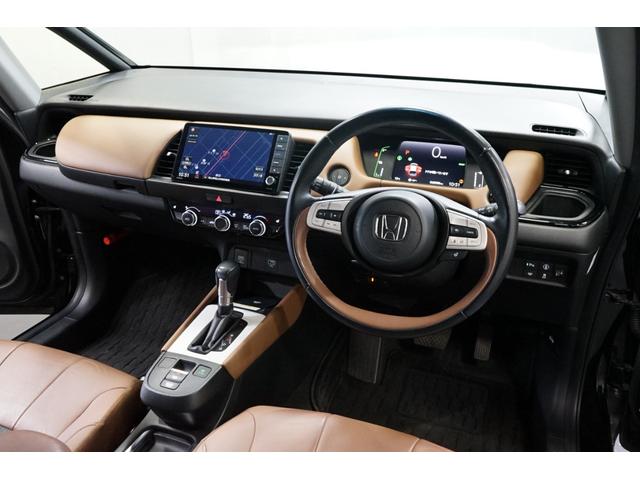 フィット ｅ：ＨＥＶリュクス　禁煙車　ホンダセンシング　Ｇａｔｈｅｒｓ製９インチナビ　バックカメラ　衝突軽減　レーダークルーズ　ハーフレザー　スマートキー　ＥＴＣ　フルセグＴＶ　ＣＤ／ＤＶＤ再生　Ｂｌｕｅｔｏｏｔｈ接続　点検記録簿（2枚目）