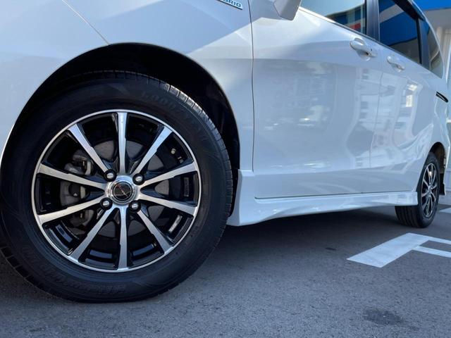 フリードハイブリッド ハイブリッド プレミアムエディション 両側電動スライドドア 純正ナビ バックカメラ 禁煙車 スマートキー ETC クルコン オートライト オートエアコン Bluetooth CD/DVD再生 フルセグ 革巻きステアリング(13枚目)