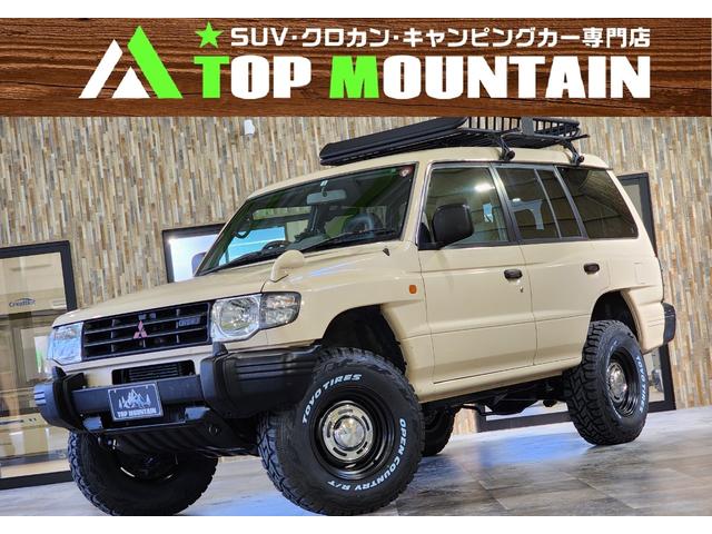 ワイド　スーパーエクシード　切替４ＷＤ　ベージュ全塗装　リフトアップ　ＤＥＡＮクロスカントリー　ヒッチメンバー　ルーフラック　背面キャリア加工　グレー革シート　シートヒーター　サンルーフ　ＥＴＣ　ＢＴオーディオ(1枚目)