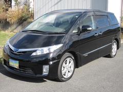 エスティマハイブリッド G レザーパッケージ 4WD大型ムーンルーフHDDナビ5.1chサウンド11SPリヤエンターテイメント本革快適温熱シートフロントサイドバックモニタインテリパーキングアシストパワーバック両電ドア電動格納サードシート寒冷地仕様 中古車画像