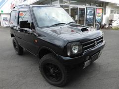 ジムニー ワイルドウインド リフトアップカスタム 社外前後バンパ 4WD キーレスエントリー シートヒーター AT ABS CD ルーフレール アルミホイール 衝突安全ボディ エアコン 中古車画像