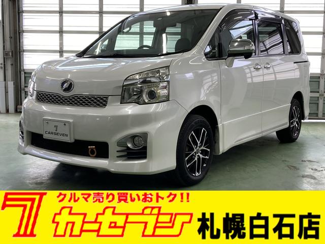 トヨタ ヴォクシー ＺＳ　煌Ｚ　４ＷＤ　ワンオーナー　寒冷地仕様　夏冬タイヤ　フリップダウン　バックカメラ　ＳＤナビ　社外ＨＩＤ　ＥＴＣ　両側電動スライドドア　１５インチＡＷ　電動格納ミラー　社外エンジンスターター　スマートキー