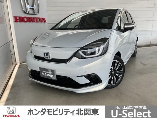 フィット ｅ：ＨＥＶリュクス　・ひょう害現状販売車　ＣＭＢＳ　Ｂモニター　ＥＴＣ付　ナビ＆ＴＶ　助手席エアバッグ　シートヒーター　コーナーソナー　サイドカーテンエアバック　ＬＥＤヘッドランプ　キーレス　フルセグ　ＡＢＳ　ＶＳＡ（1枚目）