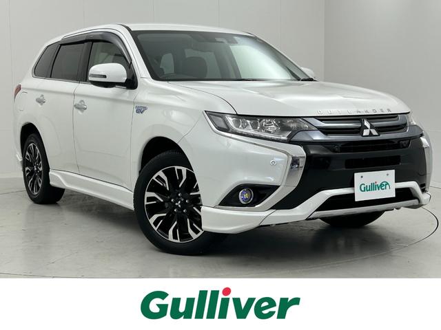 三菱 アウトランダーＰＨＥＶ Ｇプレミアムパッケージ　４ＷＤ　衝突軽減　レーンアシスト　純正ナビ　フルセグＴＶ　後席モニター　全周囲　ＥＴＣ　電動リアゲート　黒革　シートヒーター　ハンドルヒータ　ＢＳＭ　コーナーセンサー　ＡＣ１５００Ｗ　ＬＥＤ　１８ＡＷ