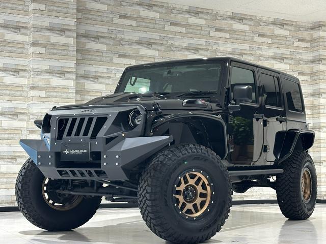 ジープ・ラングラーアンリミテッド スポーツ 1年保証付/4インチリフトアップ/フルセグ/ETC/フラットフェンダー/社外サイドステップ&前後バンパー/ラフカントリー シートカバー/4本出しマフラー/PRO COMP17inchAW(1枚目)