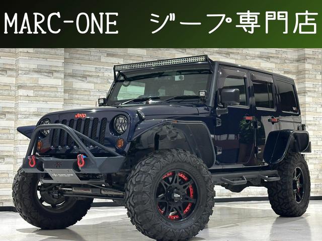 ジープ・ラングラーアンリミテッド(ジープ) サハラ　１年保証付／茶革シート／ヒーター付／AftermarketＦ＆Ｒバンパー／リフトアップ／フラットフェンダー／ＧＩＢＳＯＮマフラー／Aftermarketサイドステップ／Ｓ＆Ｂカメラ／フルセグ／Ｂｌｕｅｔｏｏｔｈ音楽／ＥＴＣ／Aftermarket１８ＡＷ 中古車画像