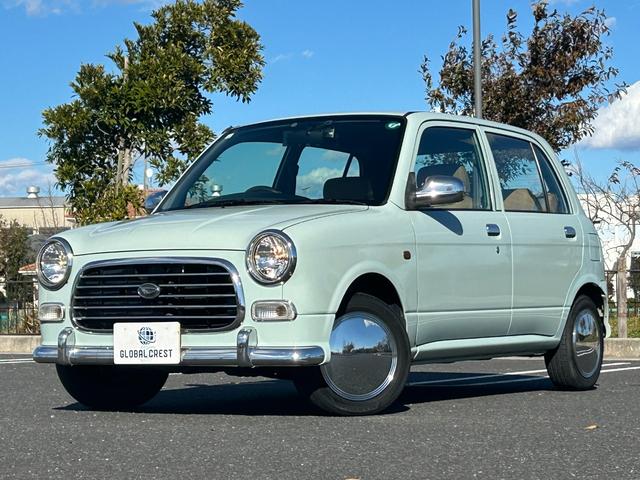 ミラジーノ(ダイハツ) ジーノ　修復無　後期型　アーバンカーキ全塗装　走行４５０００ｋｍ　衝突感知安全システム　ｓｔｒａｄａ７型ナビ・ＢＴ・ＴＶ　ウッドコンビステアリング・インパネ　肌色半革調シート　ＥＴＣ　キーレス　ホイールカバー 中古車画像