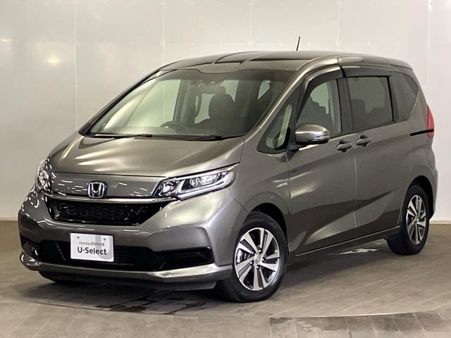 フリードハイブリッド ハイブリッド・Ｇホンダセンシング　ＥＴＣ　ナビ　前後ドライブレコーダー　シートヒーター　ＣＤ　ＤＶＤ　フルセグＴＶ　ＵＳＢ　Ｂｌｕｅｔｏｏｔｈ　軽減ブレーキ　キーフリーシステム　１オ－ナ－　記録簿　サイドカーテンエアバック　ＥＣＯＮ（1枚目）