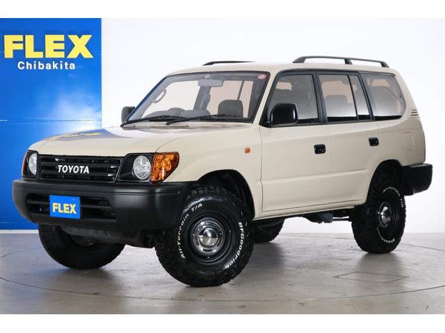 トヨタ ランドクルーザープラド その他 ｔｘ 丸目フェイス換装 ナローボディー化 マットブラック ｄｅａｎクロスカントリー１６ａｗ ａｔタイヤ 横文字トヨタグリル オレンジクリスタルコーナーレンズ アンティーク調シートカバー ルーフレールの中古車在庫詳細