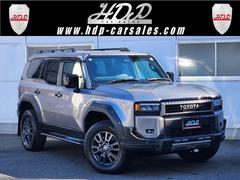 ランドクルーザー250 VX 登録済未使用・屋内保管・トヨタチームメイト・ヒッチメンバー・AUTHOR ALARM・JAOSエアロ・1STエディション専用パーツ・パドルシフト・置くだけ充電・サイドバイザー・コーティング・車両鑑定書 中古車画像