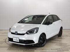 フィット e:HEVホームブラックスタイル 禁煙車 コネクトナビ6SRS マルチビューカメラ フルセグ Bluetooth USB 純前後ドラレコ LED ETC 革巻ハンドル ECON 15アルミ ブラインドスポットインフォ+後退出庫サポート 中古車画像