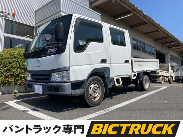 タイタンダッシュ ＷキャブワイドローＤＸ　Ｗキャブ低床リヤＷタイヤ５ＭＴガソリン車　集中ドアロック６名乗車ＥＴＣ車載器付き荷台シート付木製荷台鉄板張りパワーウィンド付き左側電格ミラー最大積載量１２５０ｋｇシートカバー付きシガ付き（1枚目）