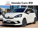 フィット ｅ：ＨＥＶホーム　純正９インチナビＴＶ・モデューロエアロ・前後ドライブレコーダー・Ｂｌｕｅｔｏｏｔｈ・バックカメラ・ワンオーナー車　前後誤発進抑制機能　助手席エアバッグ　運転席エアバッグ　１オナ　アイドリングストップ（1枚目）
