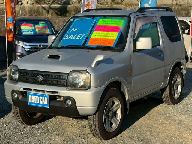 ジムニー(スズキ) ＸＣ　６型ＡＴ　４ＷＤ　ターボ　ＳＤナビ　フルセグ　Ｂｌｕｅｔｏｏｔｈ　ＤＶＤ再生　キーレスエントリー　ＥＴＣ　ヘッドライトレベライザー　電動格納ミラー　ルーフキャリア　フォグランプ　禁煙車　取説　記録簿 中古車画像