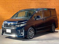 ヴォクシー ZS 4WD/寒冷地仕様/両側電動スライドドア/フリップダウンモニター/エンジンスターター付属/純正9型フルセグナビ/バックカメラ/ビルトインETC/LEDヘッドライト 中古車画像