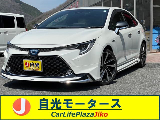 カローラ ハイブリッド　ダブルバイビー　４ＷＤ　モデリスタエアロ　ドラレコ　ＥＴＣ　クリアランスソナー　レーンアシスト　オートクルーズコントロール　衝突被害軽減システム　バックカメラ　ナビ　ＴＶ　アルミホイール　オートマチックハイビーム（1枚目）