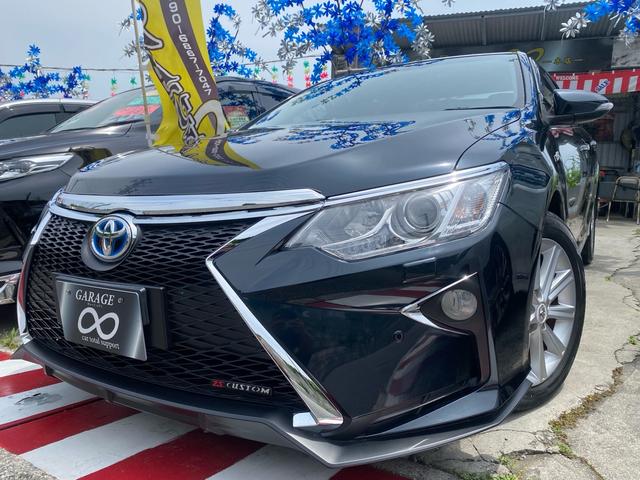 沖縄県の中古車ならカムリ ハイブリッド　Ｇパッケージ　ＺＳ　ＣＵＳＴＯＭ　スピンドルグリル　フロントバンパー　プッシュスタート　ボイスレコーダー　パワーシート　ナビ　ＴＶ　Ｂｌｕｅｔｏｏｔｈ　バックカメラ　ＥＴＣ　本土仕入れ・修復歴無し　２４ヶ月保証付