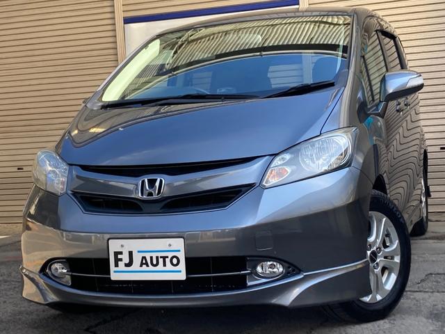 フリード(ホンダ) Ｇ　エアロ　Ｌパッケージ　禁煙車　Aftermarketナビ　フルセグＴＶ　後席モニター　８人乗り　ＨＩＤ　フォグ　ＥＴＣ　左側電動スライドドア　右側イージークローズ　キーレス　スペアキー　モデューロＡＷ　取扱説明書　運転席＆助手席エアバッグ 中古車画像