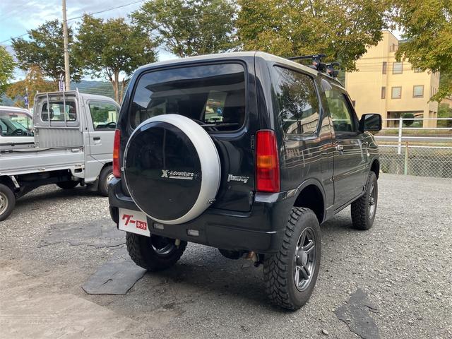 ジムニー クロスアドベンチャー 4WD 5速マニュアル リフトアップ CD/MD ETC シートヒーター キーレスエントリー 衝突安全ボディ 16インチアルミ ライトレベライザー ウインカー付き電動格納ドアミラー メッキグリル(10枚目)