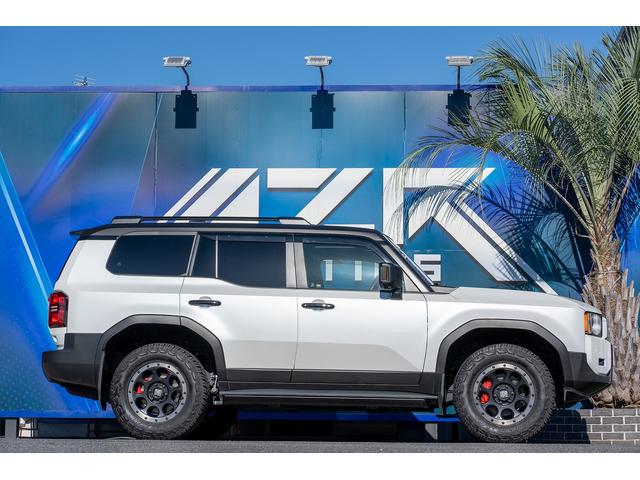 ランドクルーザー250 VX ボディーラッピング エクストリームJ サンルーフ VIPERセキュリティ 社外テールランプ(一文字テール) 社外サイドステップ 黒革シート Wエアコン ルーフレール エクストリーム18インチAW(7枚目)