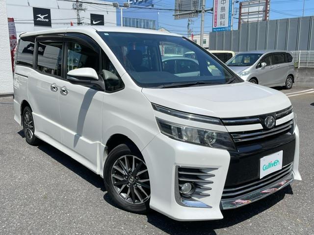 ヴォクシー ＺＳ　禁煙車　純正９型大型ナビ　後席フリップダウンモニター　オプション両側電動スライドドア　フルセグＴＶ　バックカメラ　ビルトインＥＴＣ　ＬＥＤヘッドライト　７人乗りキャプテンシート（1枚目）