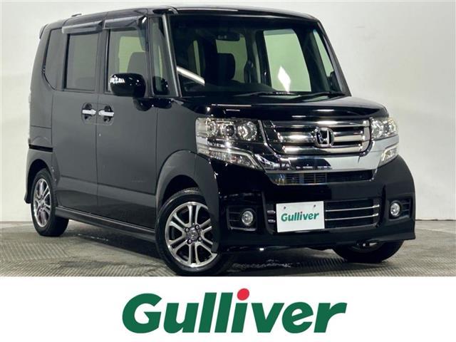 Ｎ－ＢＯＸカスタム Ｇ・Ｌパッケージ　ＢＬＵＥＴＯＯＴＨ　アイドリングストップ車　ナビ・ＴＶ　フロントベンチシート　地デジＴＶ　パワーウィンドウ　盗難防止システム　パワステ　ＤＶＤ再生可　両席エアバック　ＡＢＳ　横滑り防止　ＡＵＴＯライト（1枚目）