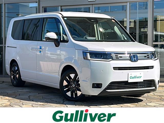 ステップワゴン(ホンダ) e:HEVエアー EX 純正ナビ バックカメラ 2列目オットマン 後席フリップダウンモニター クリアランスソナー ブラインドスポット パワーテールゲート 後席エアコン シートヒーター 全列USB 純正16インチアルミ 中古車画像