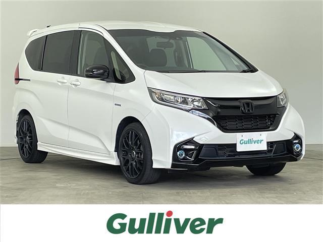 フリードハイブリッド(ホンダ) ハイブリッド・モデューロX ホンダセンシング 禁煙車 純正9インチメモリナビ 両側パワースライドドア バックカメラ ETC スマートキー&プッシュスタート 電動格納ミラー 革巻きステアリング ステアリングスイッチ 社外17インチアルミホイール 中古車画像