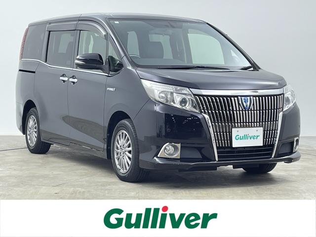 エスクァイア(トヨタ) ハイブリッドＧｉ　両側電動ドア　Aftermarket９インチメモリナビ　Ｂｌｕ−ｒａｙ　Ｂｌｕｅｔｏｏｔｈ　バックカメラ　フルセグＴＶ　革巻きステアリング　ステアリングスイッチ　ＤＮシートヒーター　置くだけ充電　純正１５インチＡＷ 中古車画像