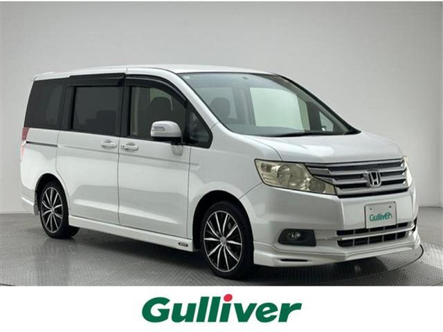 ステップワゴン（ホンダ）Ｇ　インターナビ　コンフォートセレクション　純正７インチナビ　ＣＤ　ＤＶＤ　ＨＤＤ　フルセグＴＶ　バックカメラ　両側パワースライドドア　クルーズコントロール　ＥＴＣ　社外１７アルミホイール　モデューロエアロ　ウィンカーミラー　ドアバイザー 中古車画像