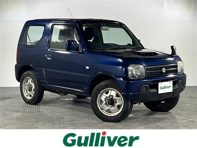 ジムニー(スズキ) ＸＧ　禁煙車　４ＷＤ　ワンオーナー　Aftermarketオーディオ　ＣＤ　ラジオ　リモコンキー　ターボ　背面タイヤ　純正フロアマット　純正ドアバイザー　フェンダーミラー　横滑り防止装置　スペアキー　取扱説明書　保証書 中古車画像